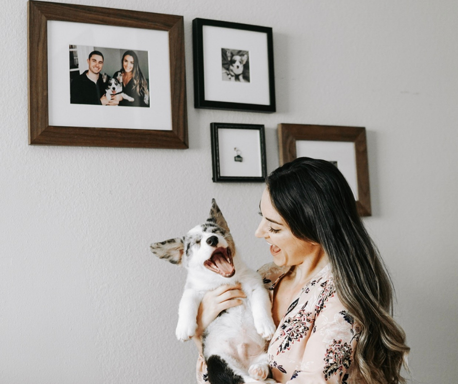 girl holding corgi puppy